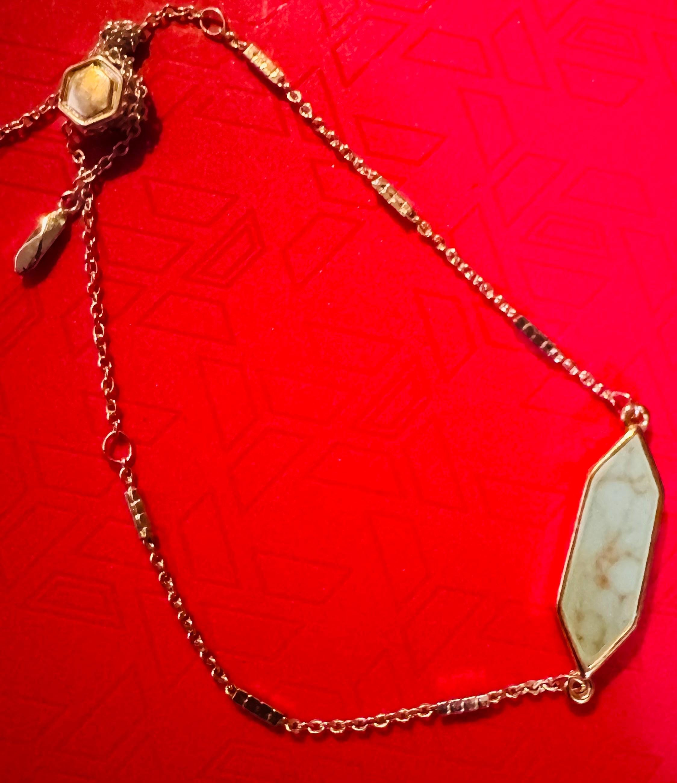 Adjustable Silver Toned Bracelet w/ Blue Colored Stone.