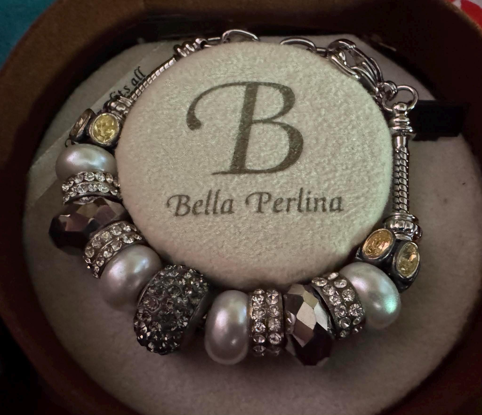 Bella Perlina Silver toned Charm Bracelet and sets of charms.